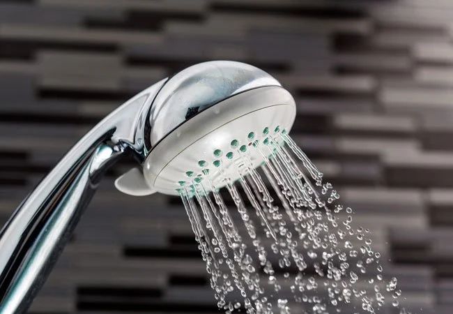 a handheld shower head spraying water