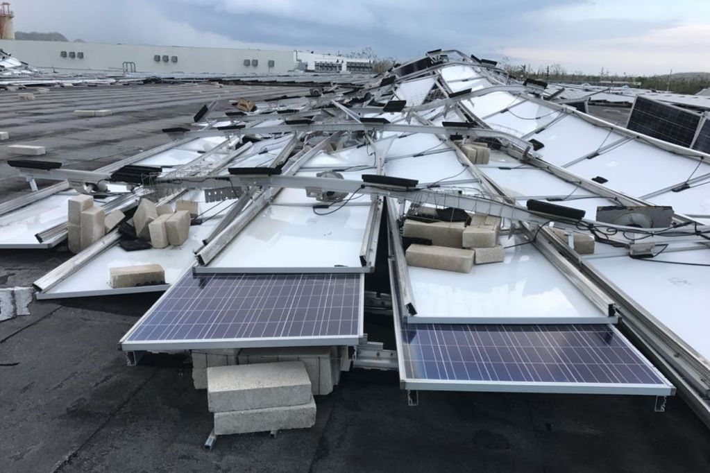 an image of solar panels on a roof being damaged by heavy rain and wind