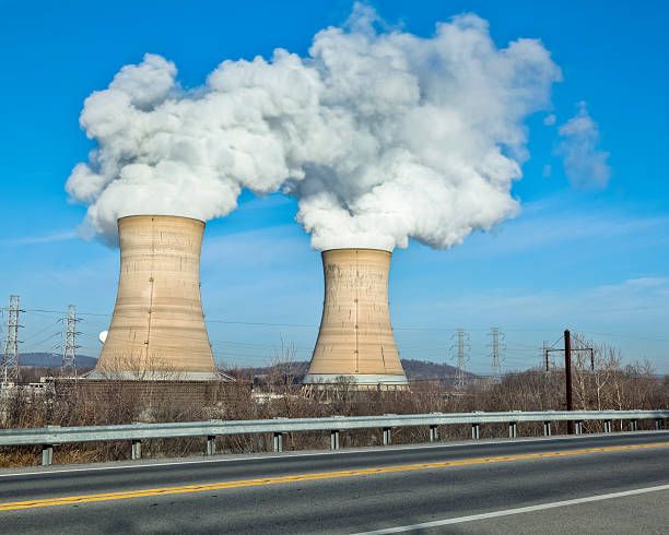 cooling towers emitting steam at nuclear plant