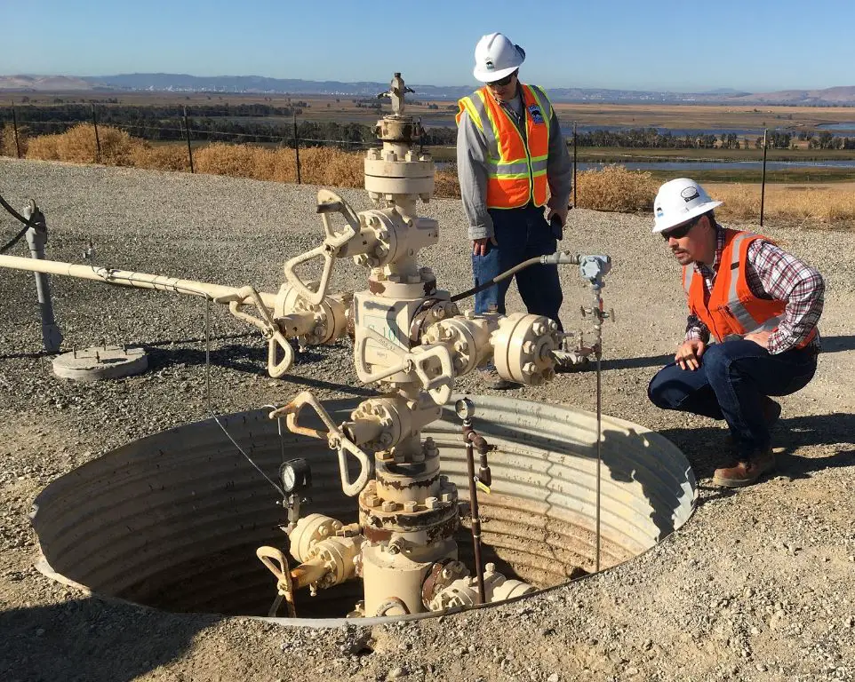 engineers inspecting a geothermal wellhead