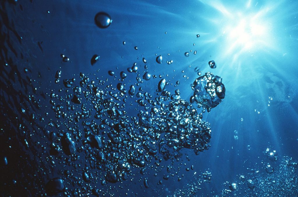 hydrogen gas bubbles rising through water