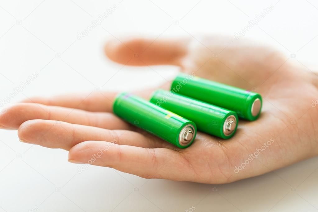 person holding a battery