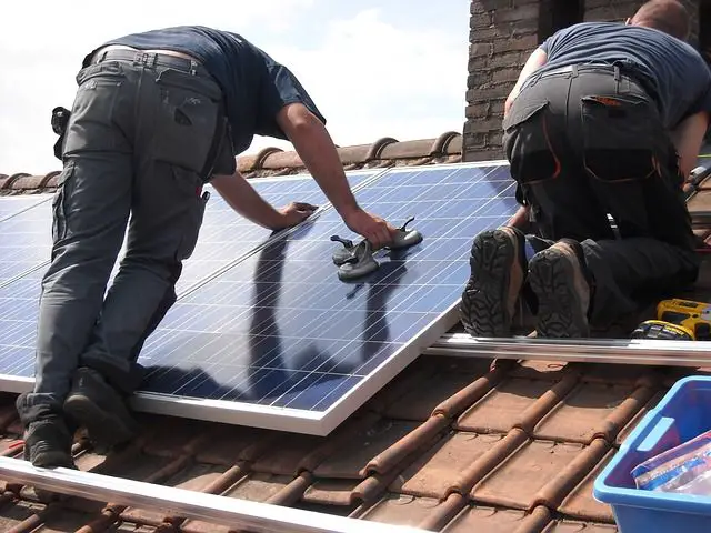 solar panels being installed on a roof to convert sunlight into electricity