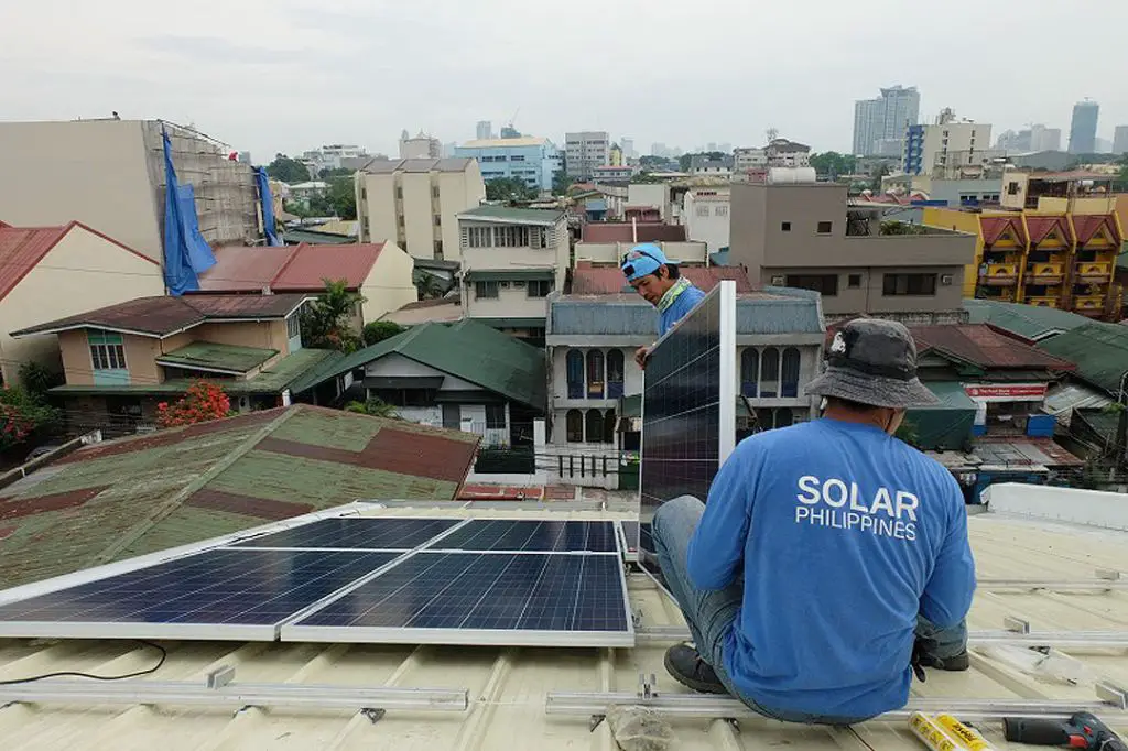 solar panels being installed on a rooftop in the philippines.