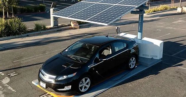 solar panels generating electricity to charge an electric car
