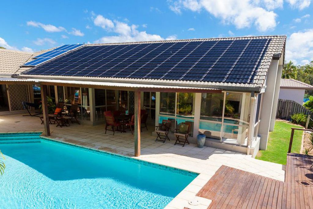 solar panels installed on a roof to heat a swimming pool.