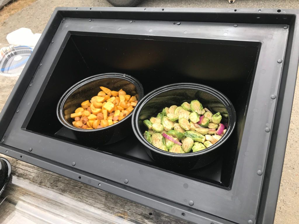 various foods cooking in a solar oven.