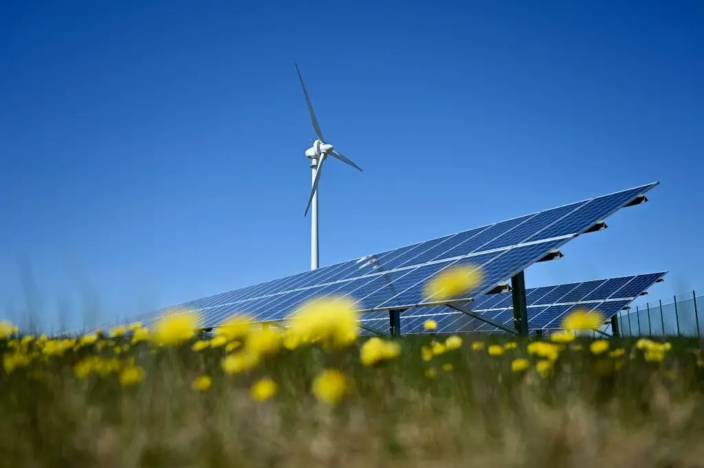 wind turbines and solar panels representing renewable energy sources