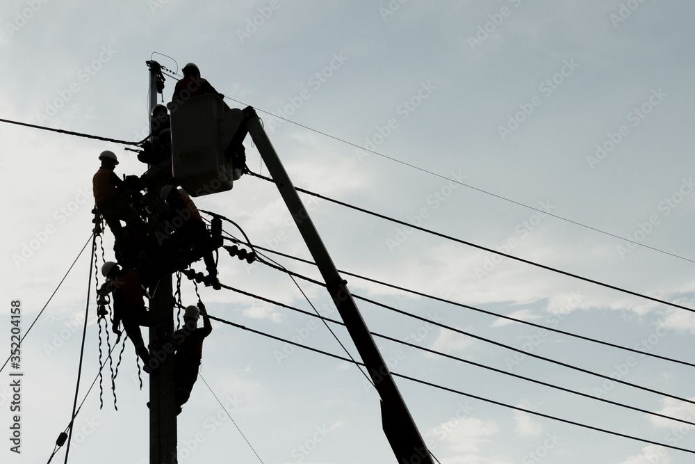 worker repairing damaged power lines after a storm