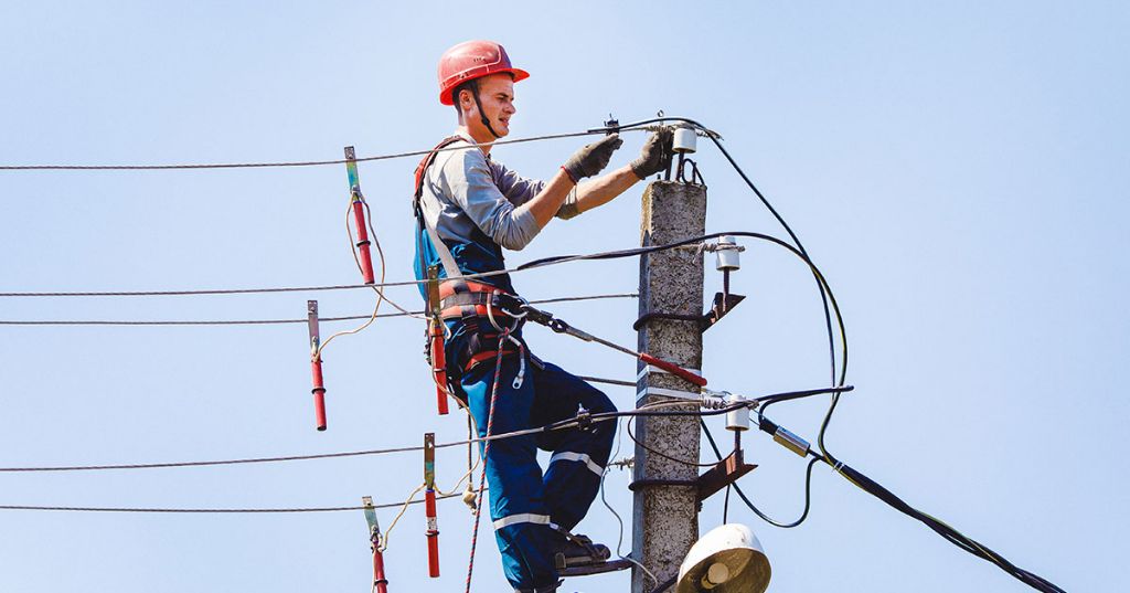 electrical workers installing high voltage transmission lines