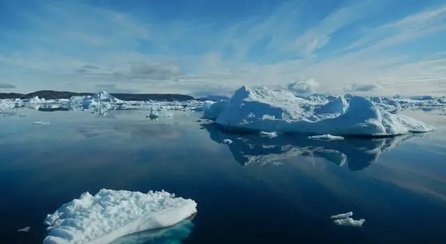 melting glacial ice flows into the ocean, contributing to sea level rise.