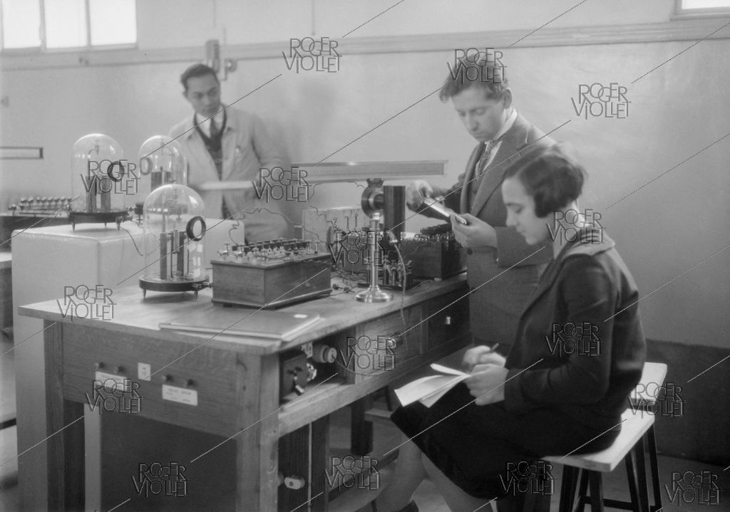 scientists in lab measuring electricity.
