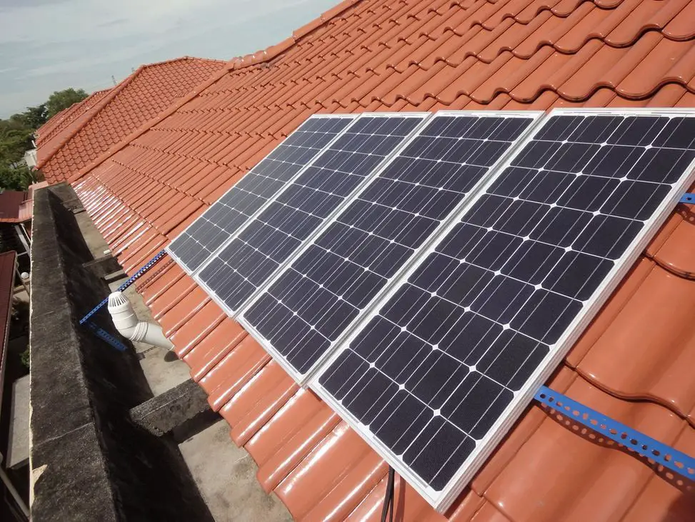 solar panels on roof of house converting sunlight to electricity