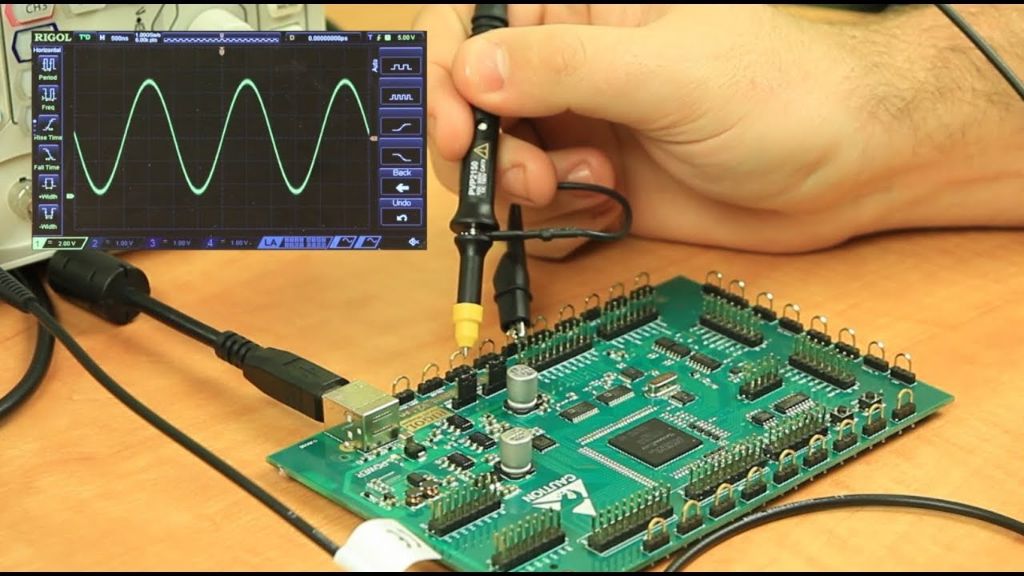 technician with oscilloscope probing circuit board.